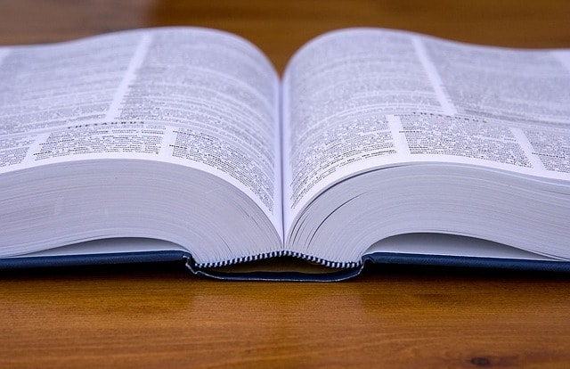 An open book on a wooden surface.