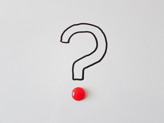 A black and white question mark with a red dot.