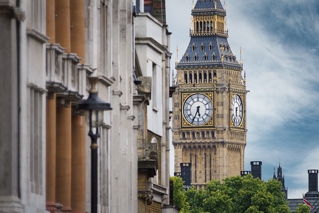 The Big Ben clock behind a building.