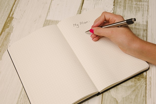 A woman writing notes under a heading that says "My plan."