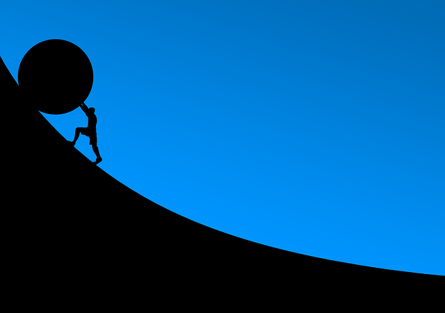 An illustration of a person pushing a rock up a hill.