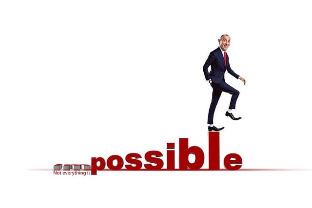 A person walking on uneven letters spelling the word "possible."