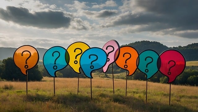 Different colored banners with a question mark inside them set in a field.