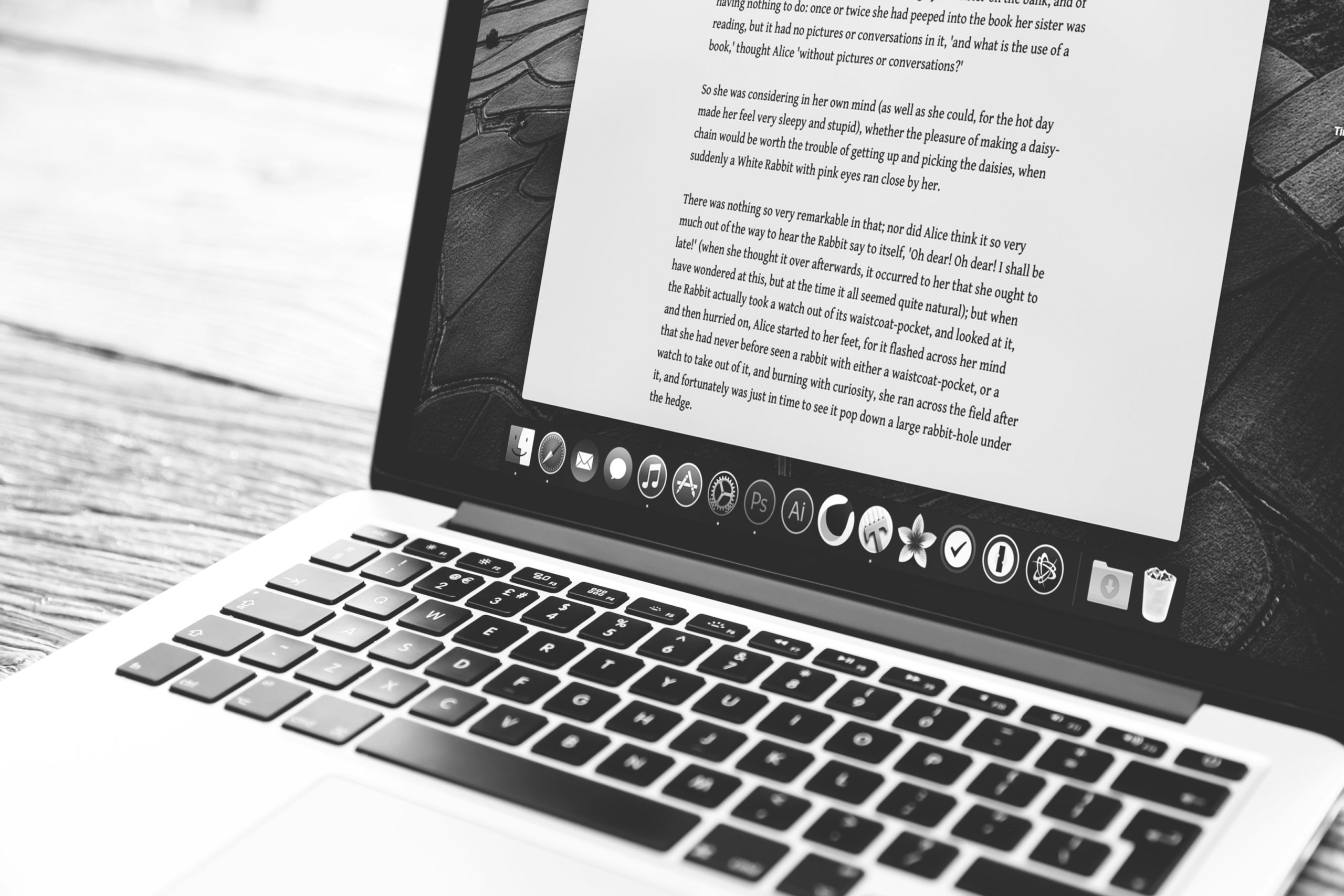 A black and white image showing a Word document on a laptop.