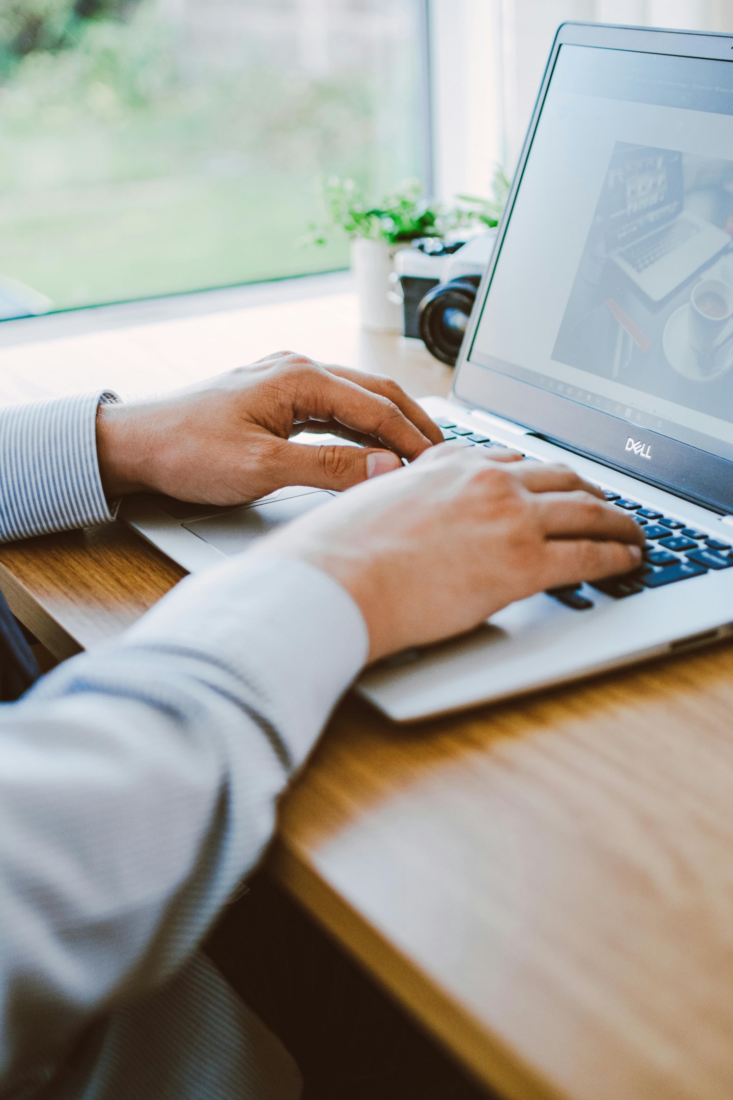 A man using a laptop at a desk. 