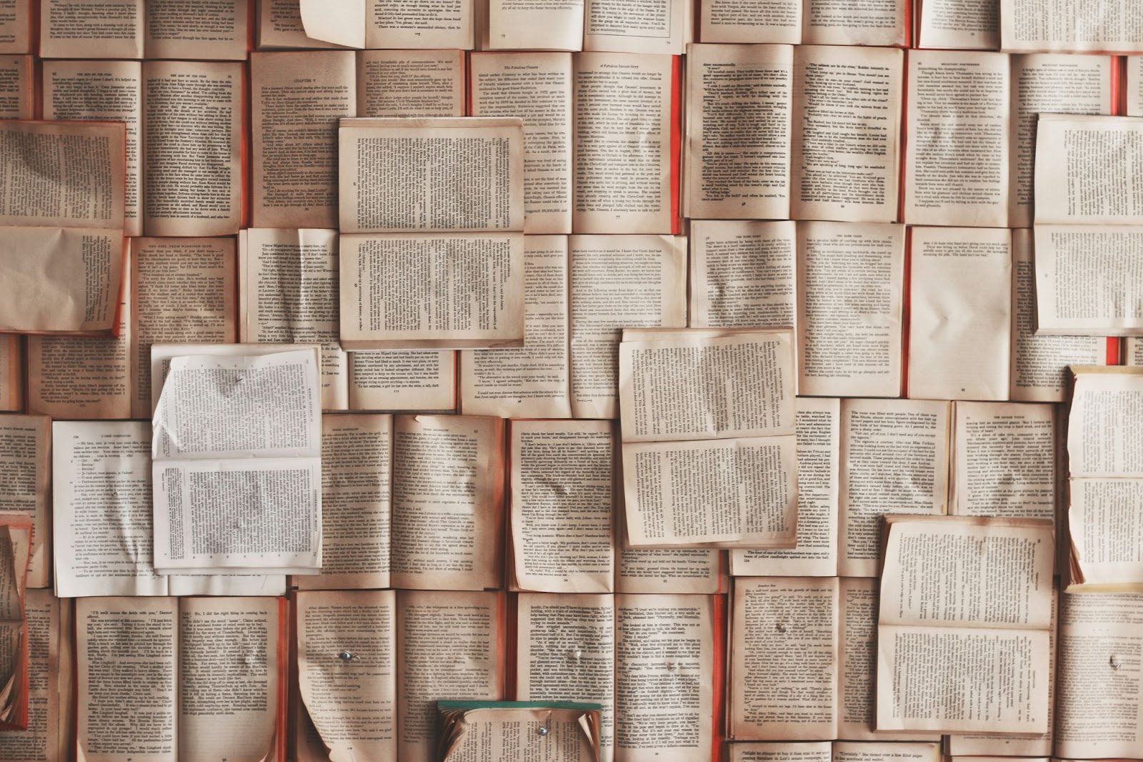 An image of lots of books open and laid out next to each other.