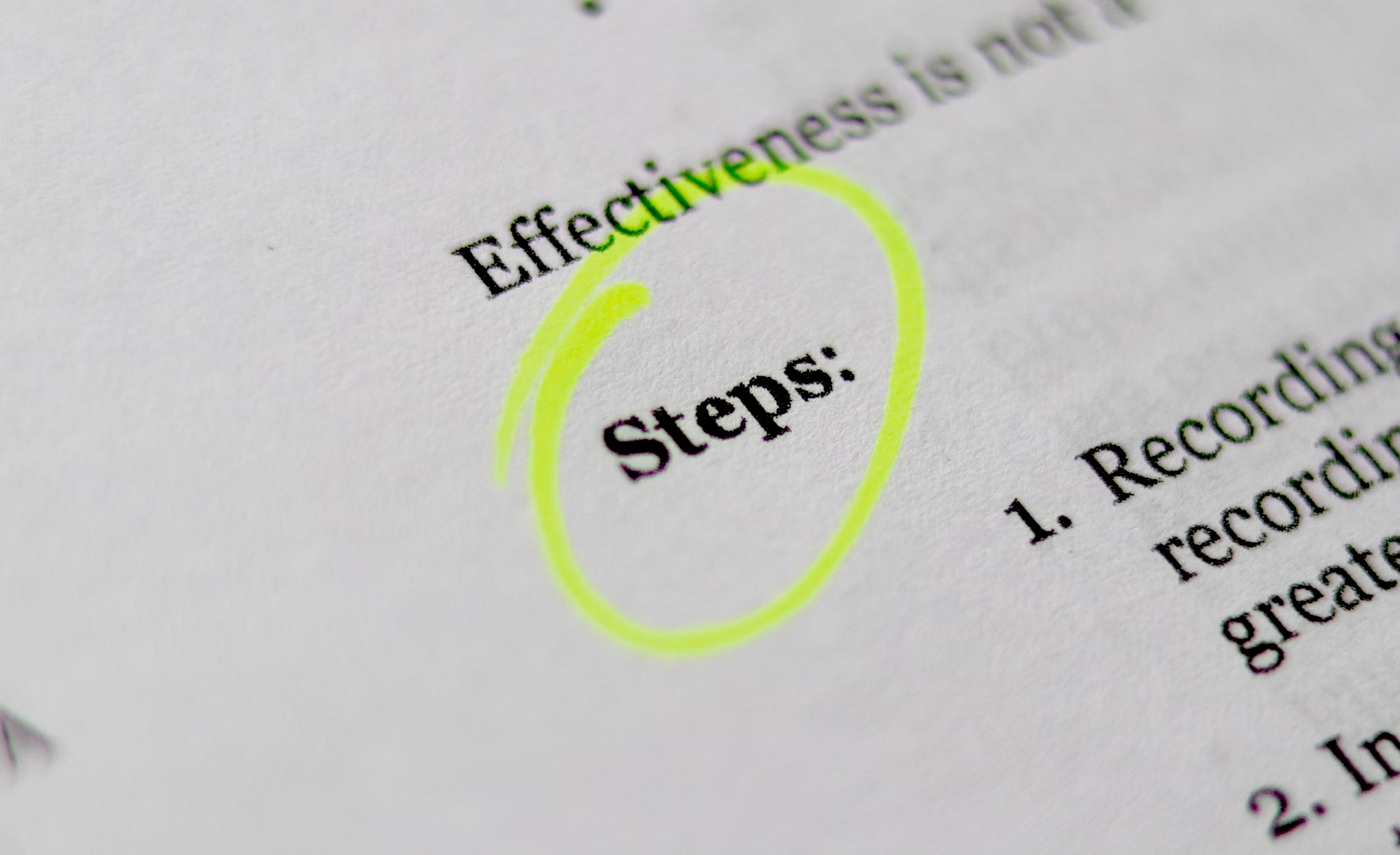 A close-up of a book, with the word “Steps” circled in a yellow highlighter.