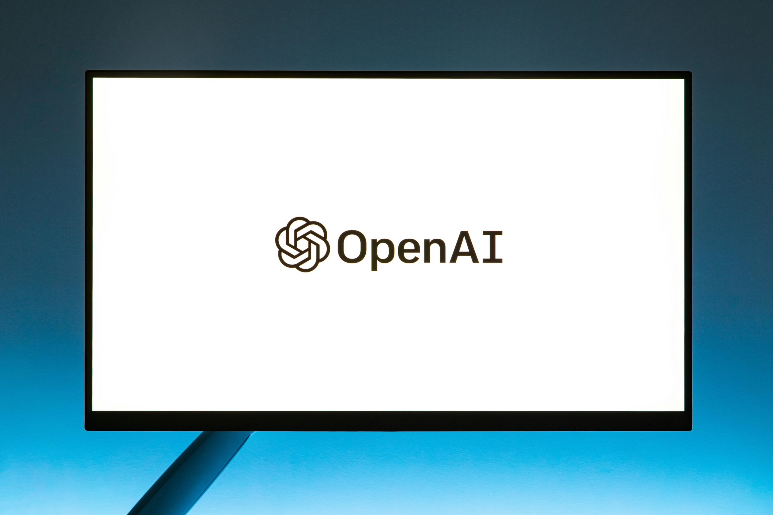 A computer monitor with the OpenAI website loading screen. 