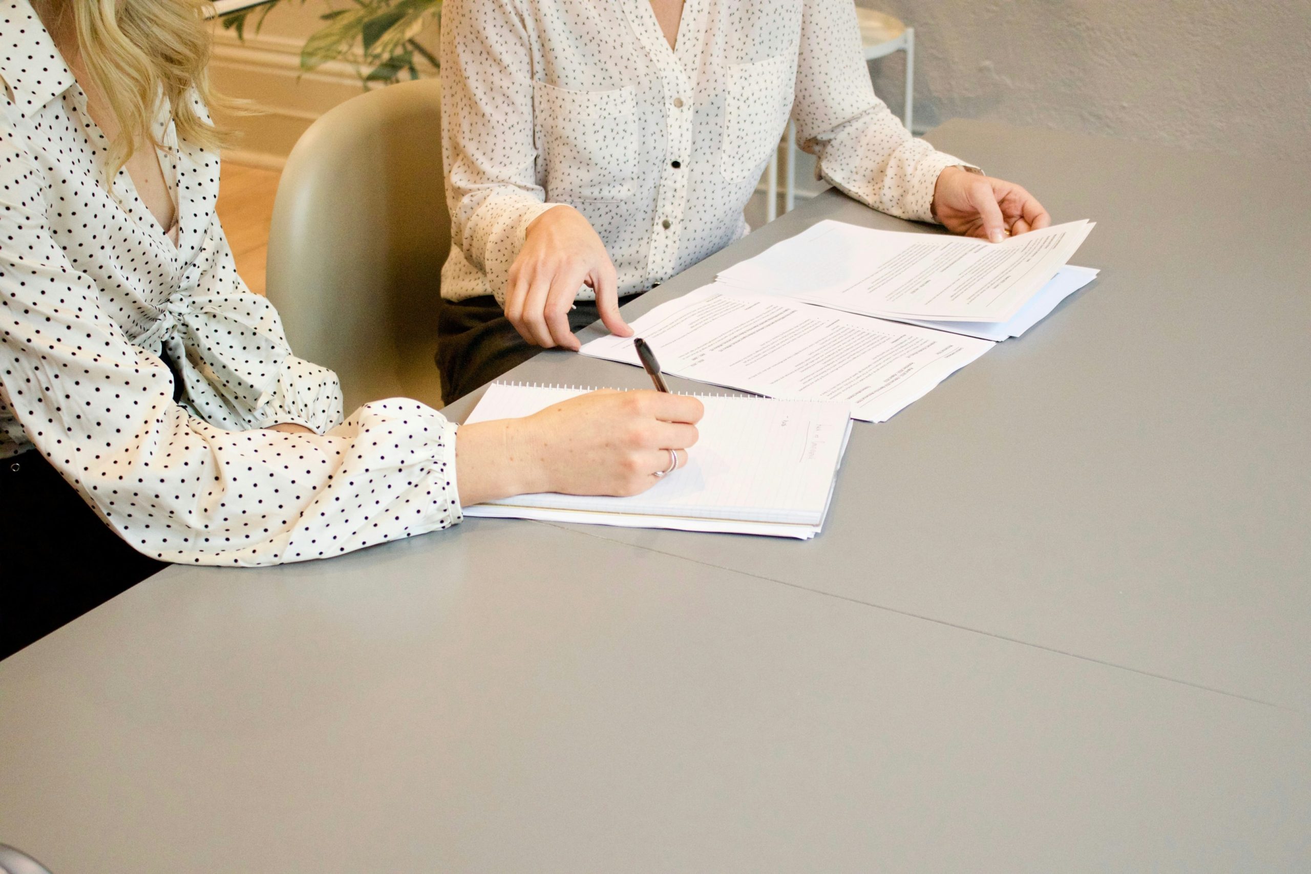 Two women looking over meeting notes