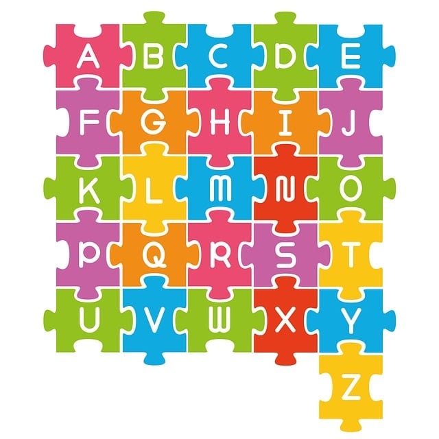 Different colored puzzle pieces of the alphabet.