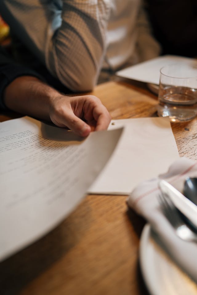 A close-up of a person reviewing an essay. 