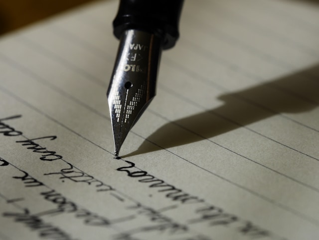 A fountain pen writing notes on a sheet of paper.