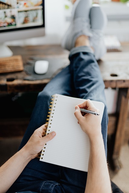 A person making notes on a notepad. 