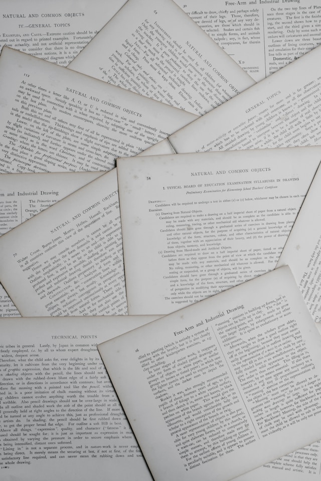 Several pages of a research article scattered on a desk. 