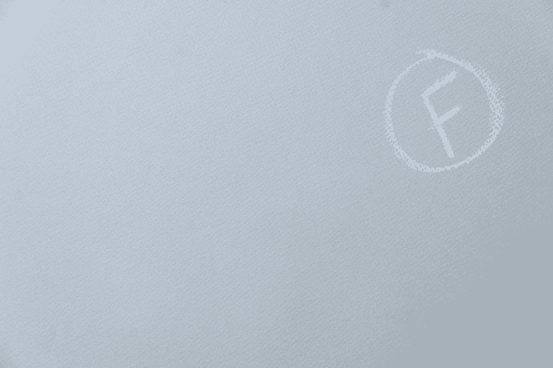 A pale white "F" in a circle drawn in chalk on a piece of grey textured paper to symbolize a bad essay grade.