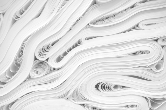 An abstract photo of stacks of paper bending inward. 