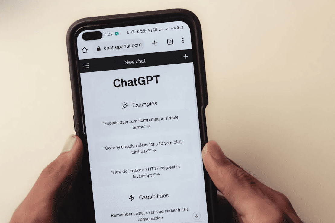  A person holding a phone with both hands and using ChatGPT. 