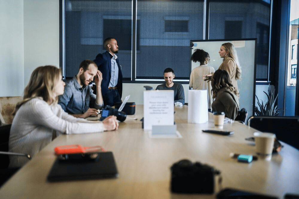 People sitting around a table in what looks to be a meeting.