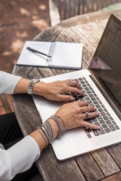 A person typing on a laptop.