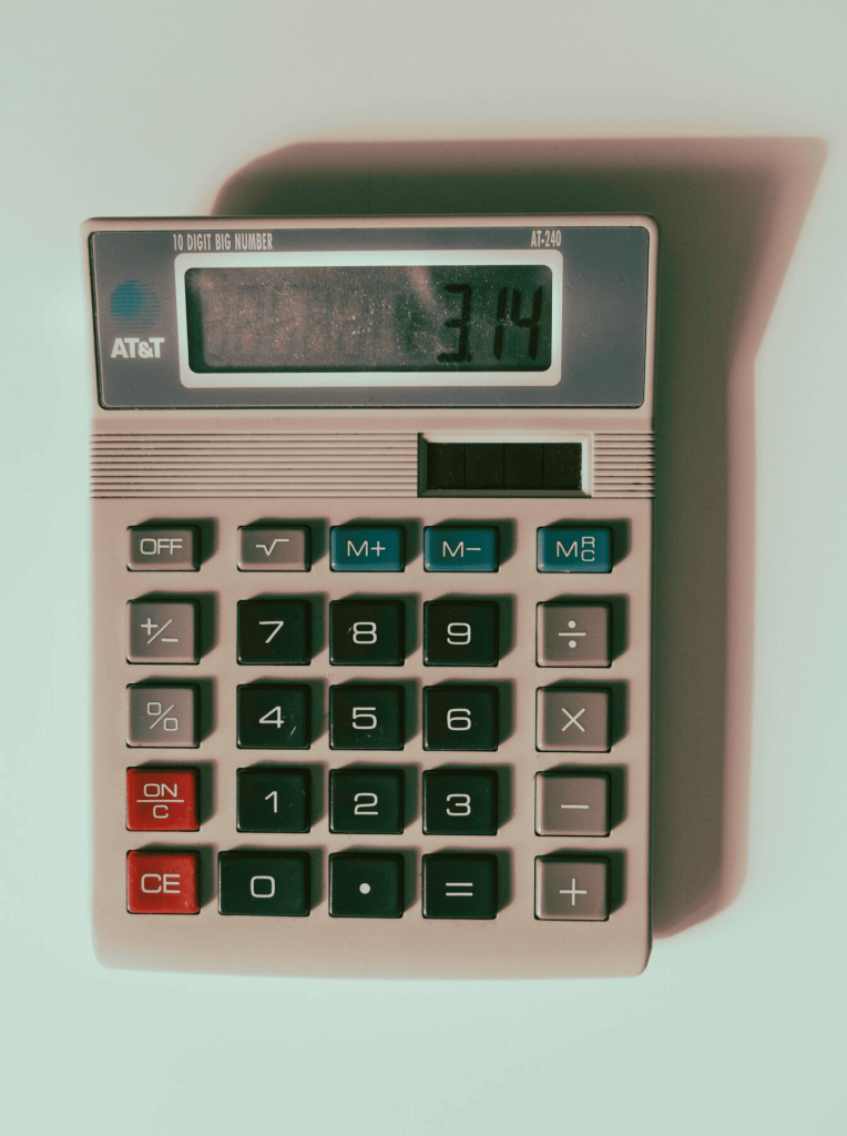 A calculator sitting on top of a desk. 