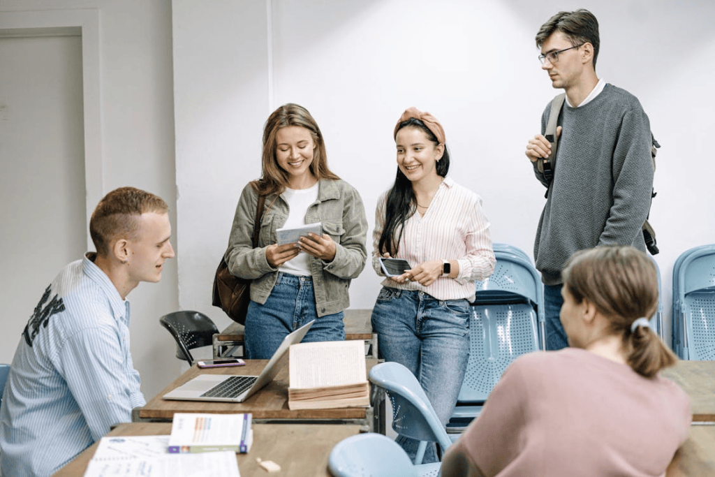 College students gathered around a table and talking. 