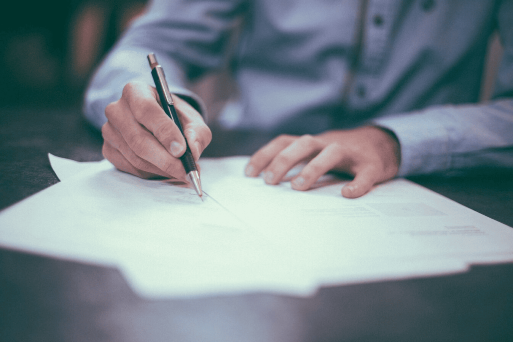 A man writing on paper. 