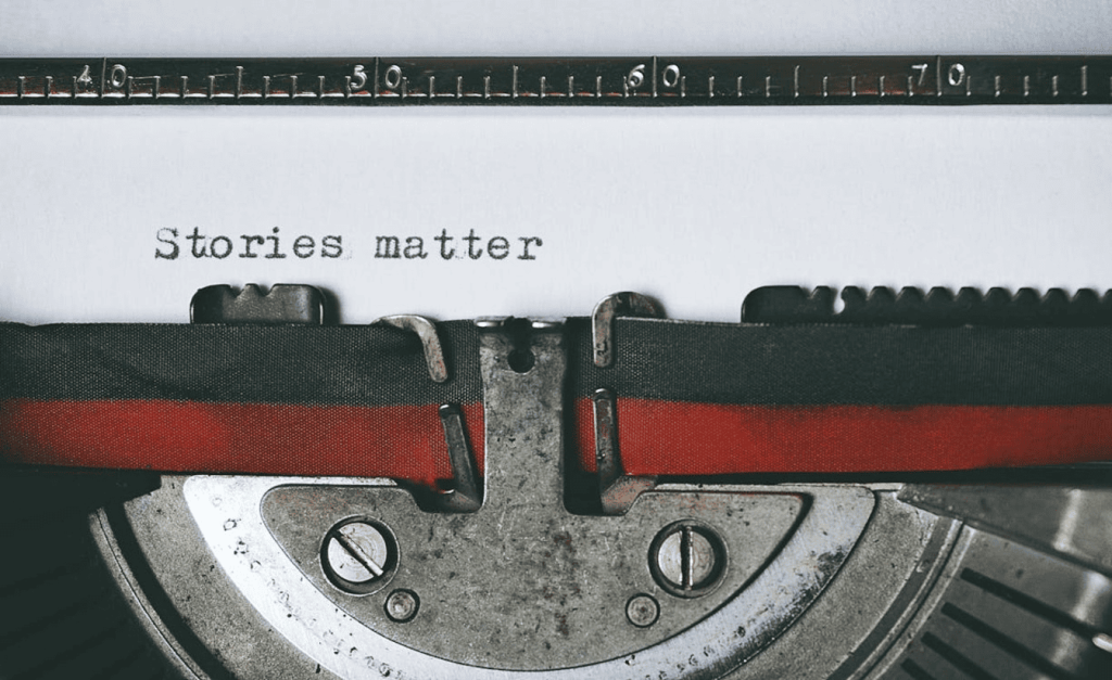 The words "Stories matter" on a white piece of paper inside a typewriter.