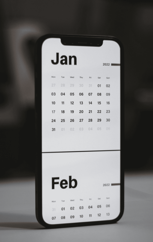 A white and black calendar showing the months of January and February on a smartphone screen.