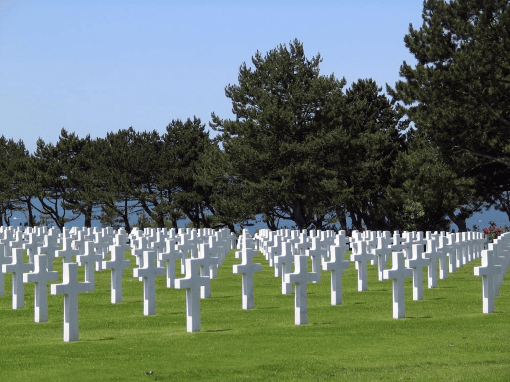 A graveyard with white crosses as the grave accents. 