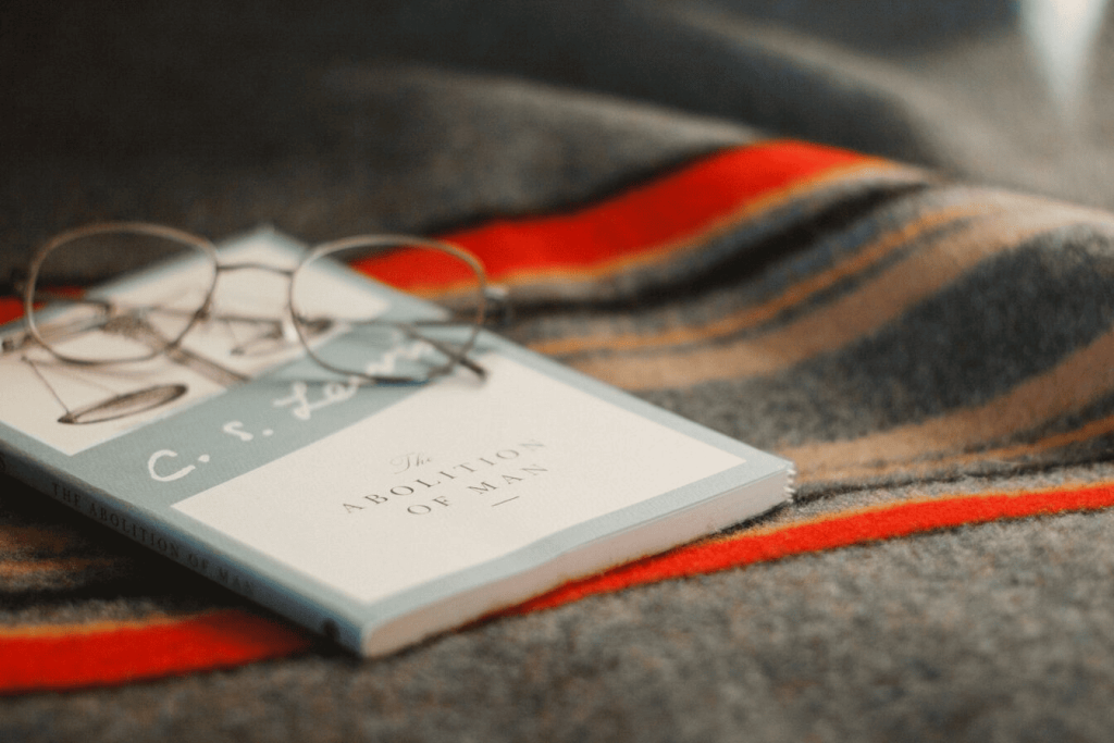 Gray reading glasses on top of a book.