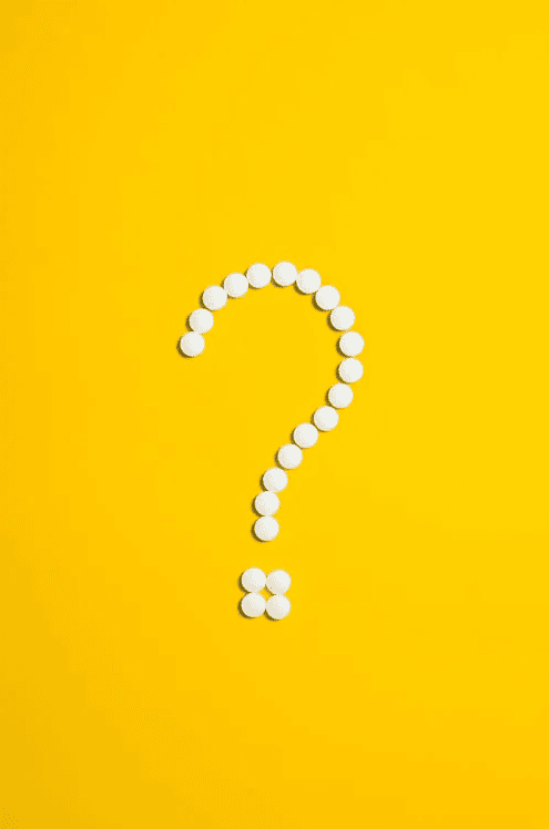 A white question mark with a yellow background.