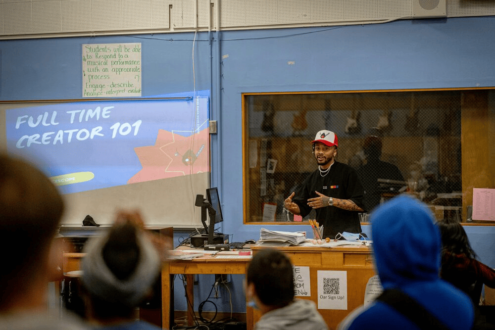 A teacher standing in front of a class. 