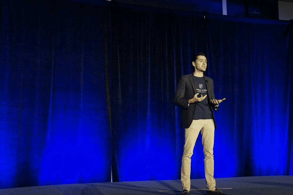 A person giving a speech on a stage. 