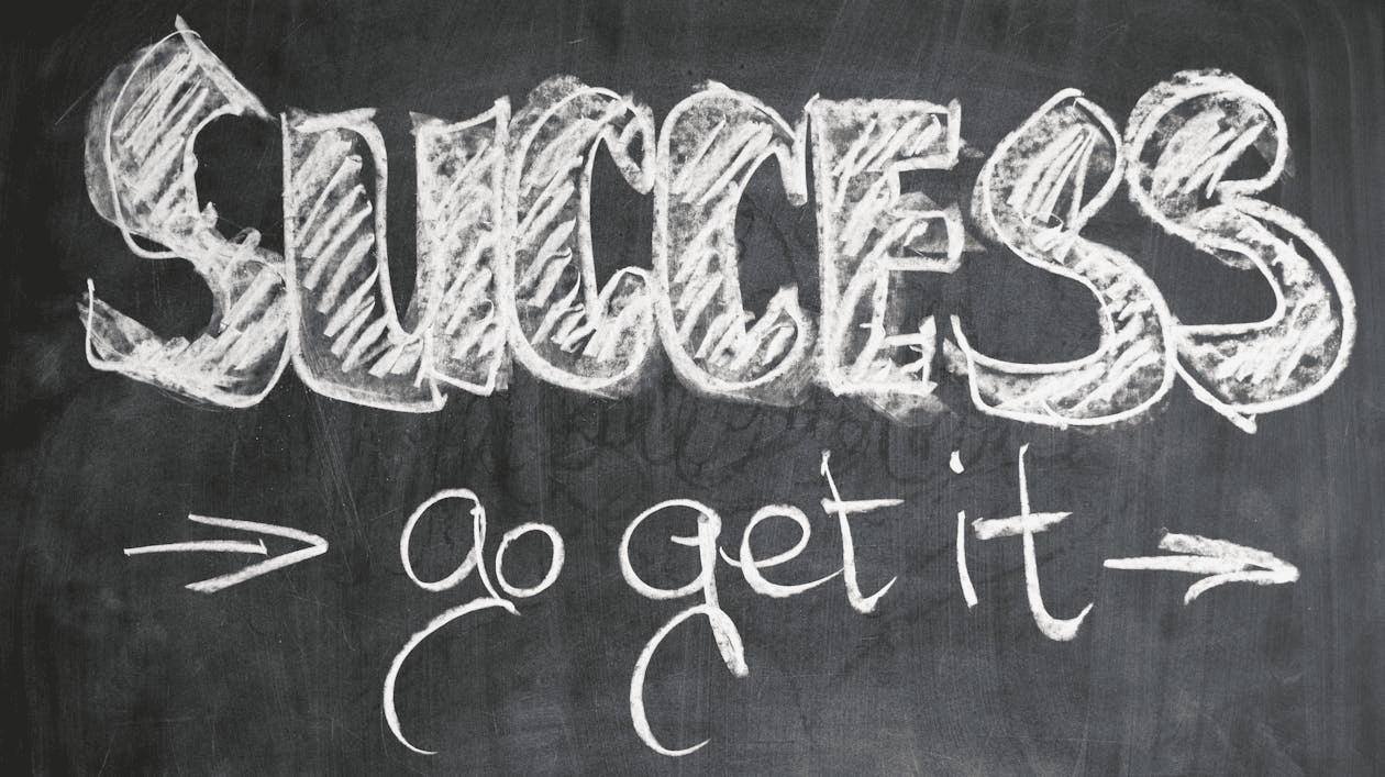 The phrase "Success go get it" on a blackboard. 