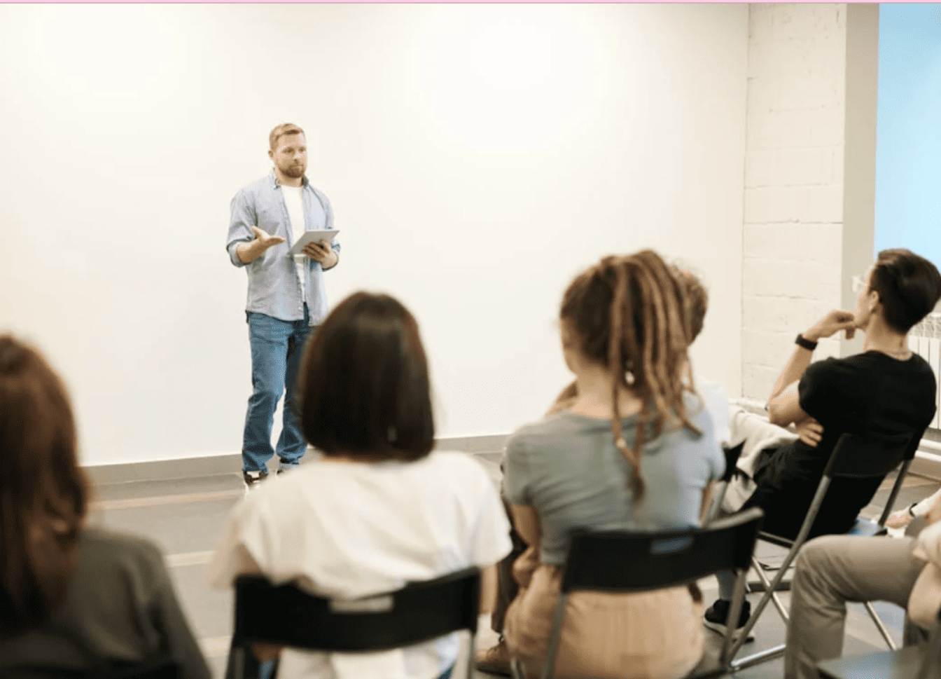 A teacher in front of a classroom of students. 