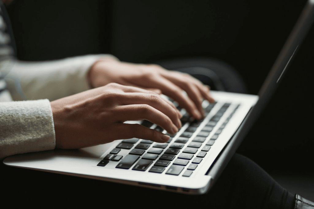 A person typing on a laptop.