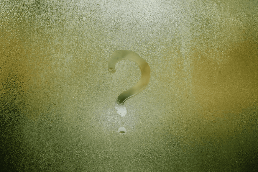 A question mark on glass. 