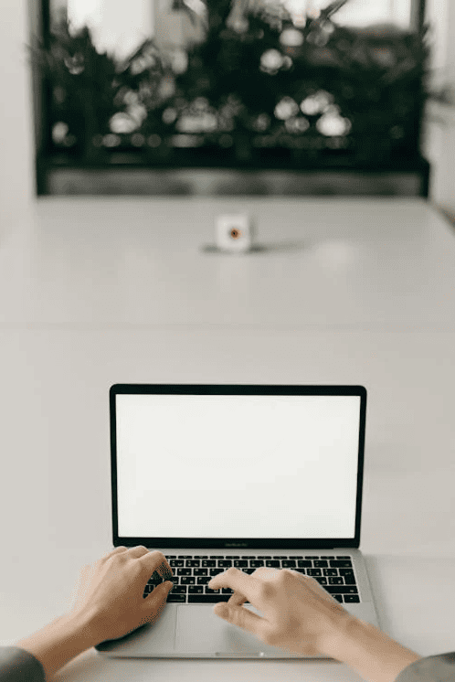 A person typing on a laptop. 