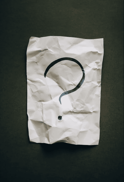 A question mark on a crumbled up piece of paper. 