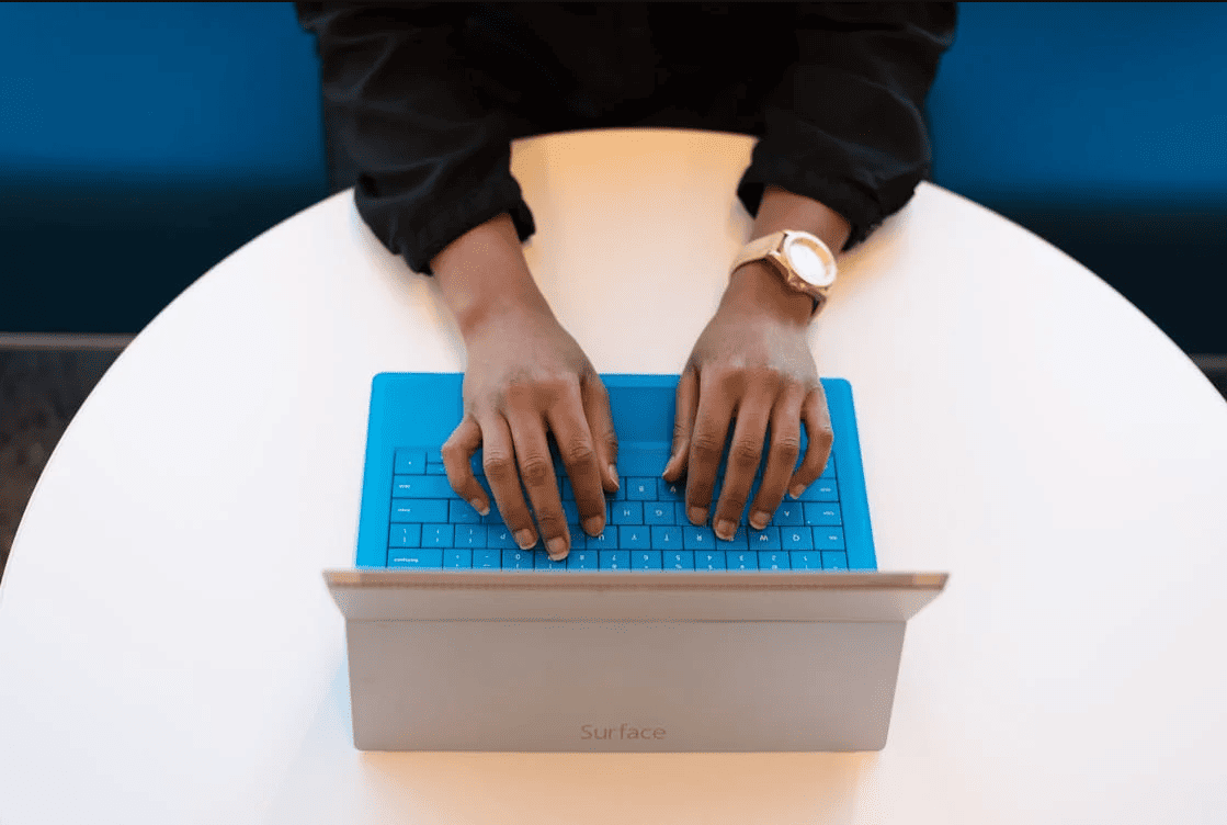 A person typing on a laptop. 