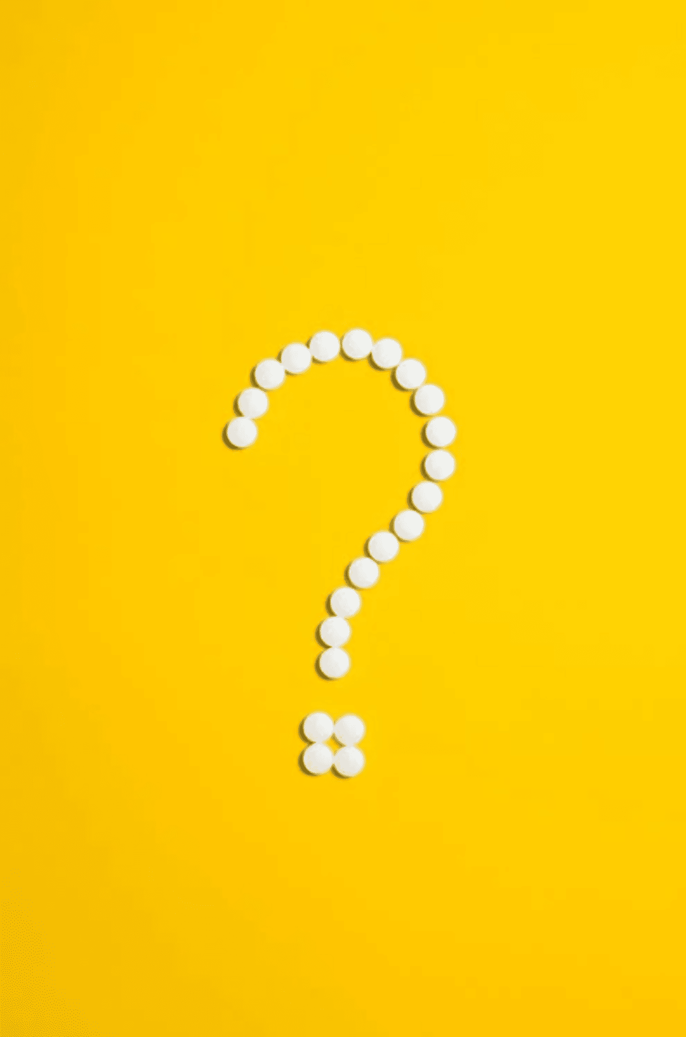 A white question mark with a yellow background. 