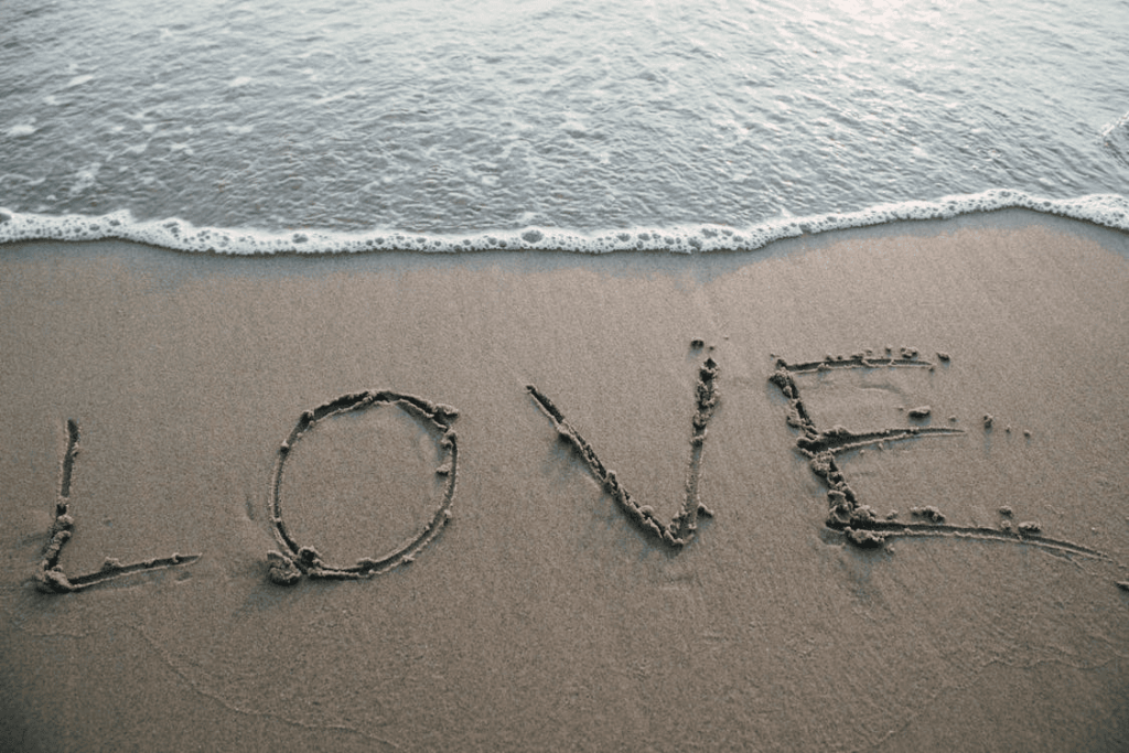 The word "love" written in sand. 