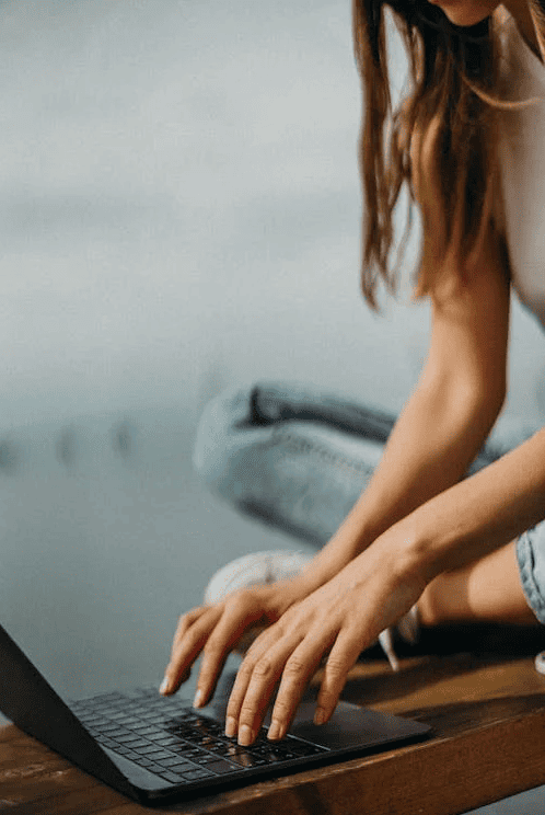 A person typing on a laptop. 