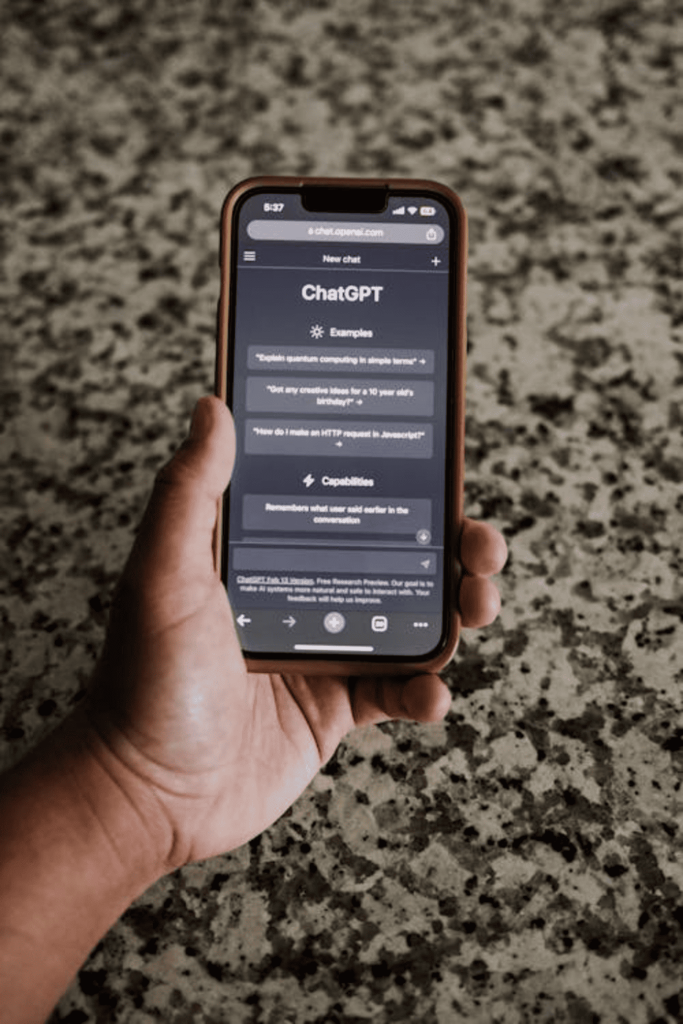 A person holding a mobile phone that's using ChatGPT. 