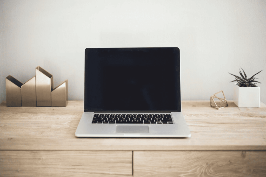 A MacBook Pro on top of brown table.