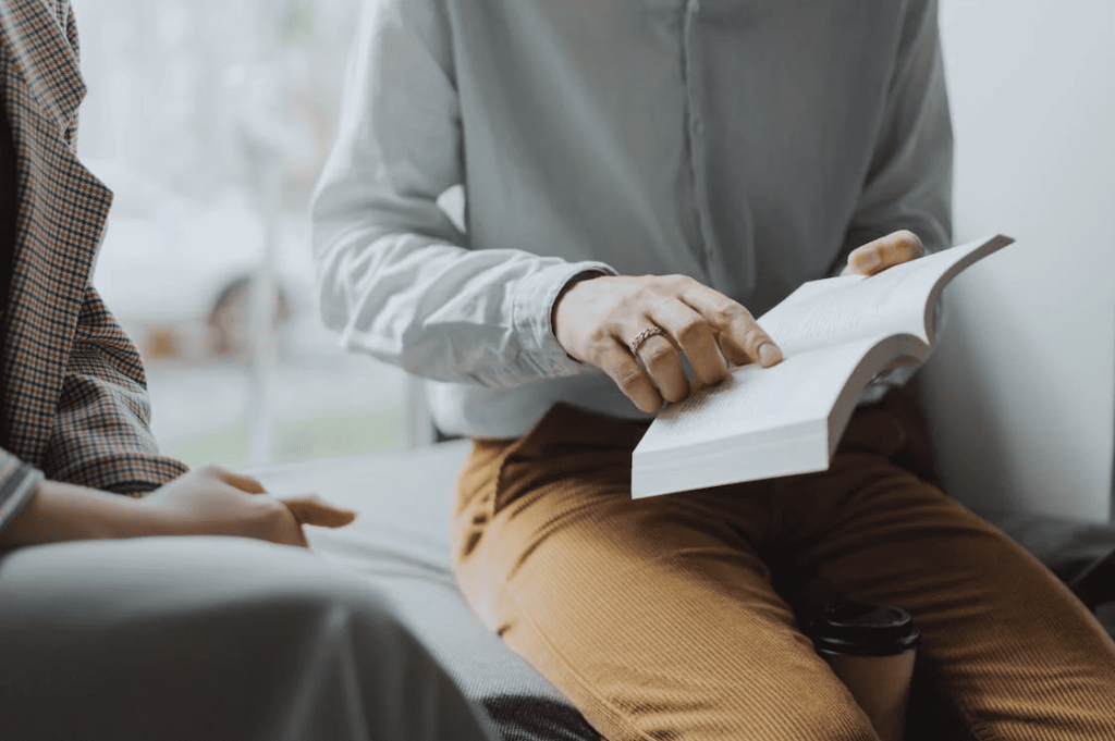 A person pointing to a section in a book. 