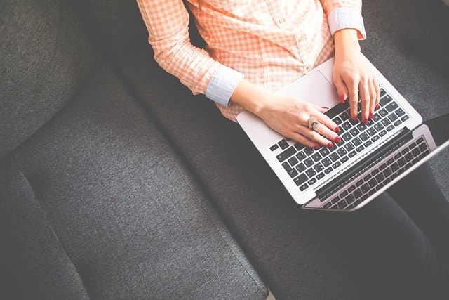 A woman typing on her laptop.