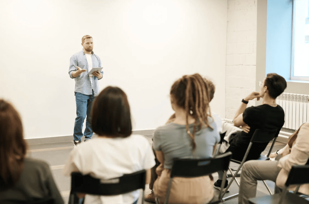 A teacher in front of a group of students. 