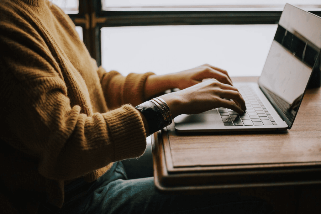 A person typing on a laptop.