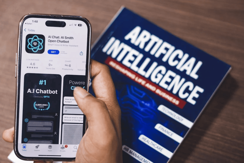 A person using an AI app with an artificial intelligence book in the background. 